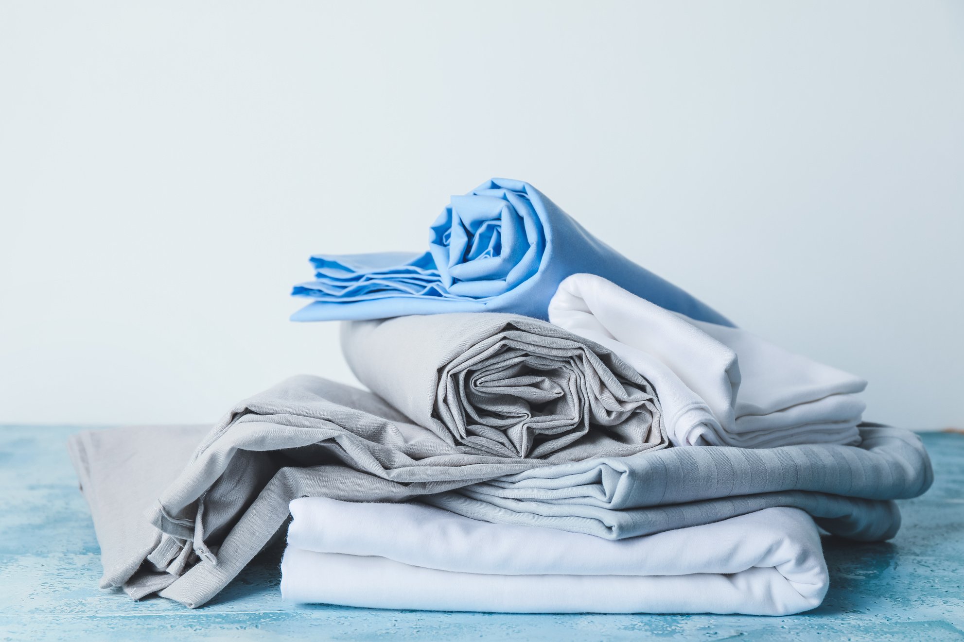 Stack of Clean Bedsheets on Table